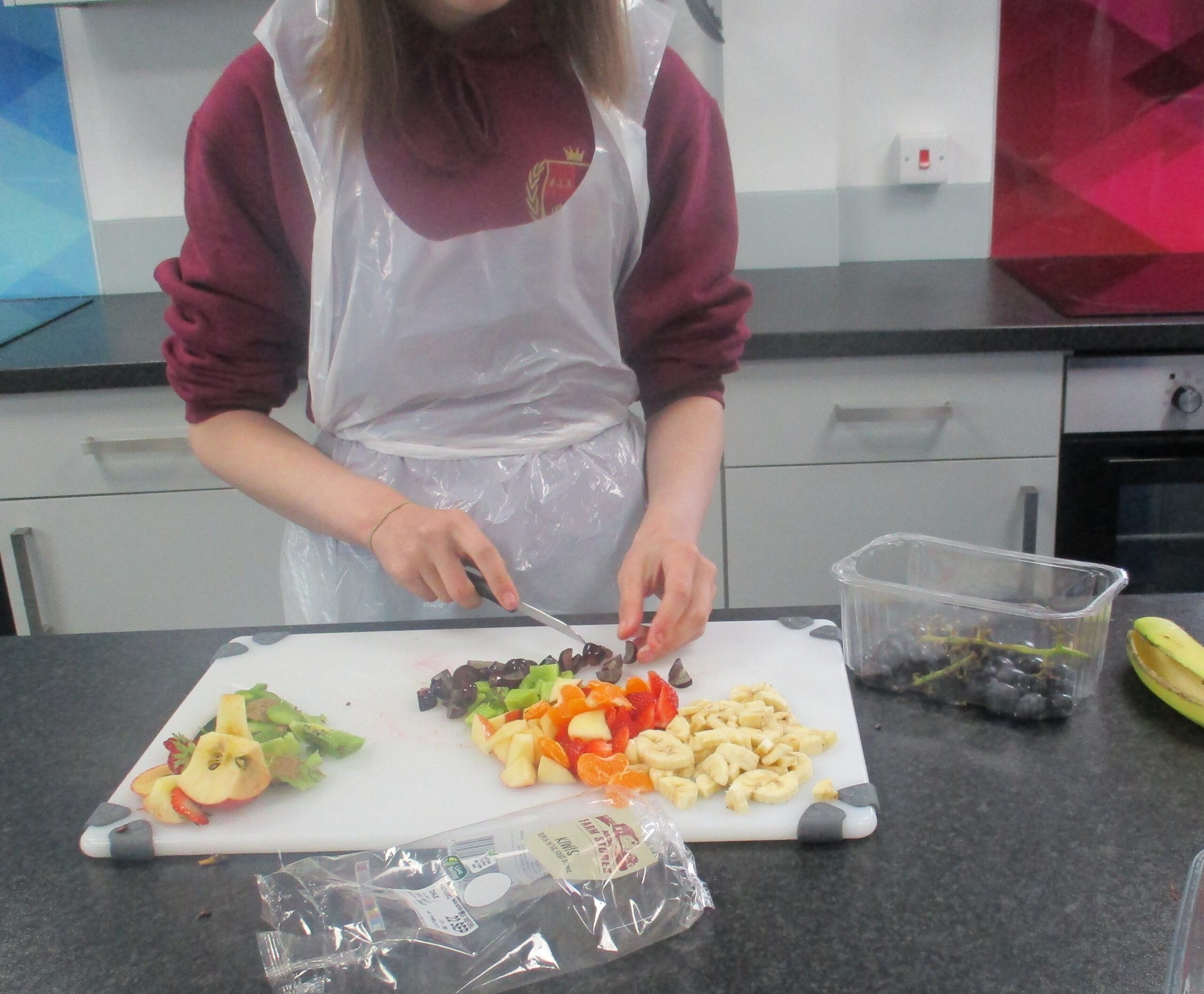 Student preparing fruit in a cooking class