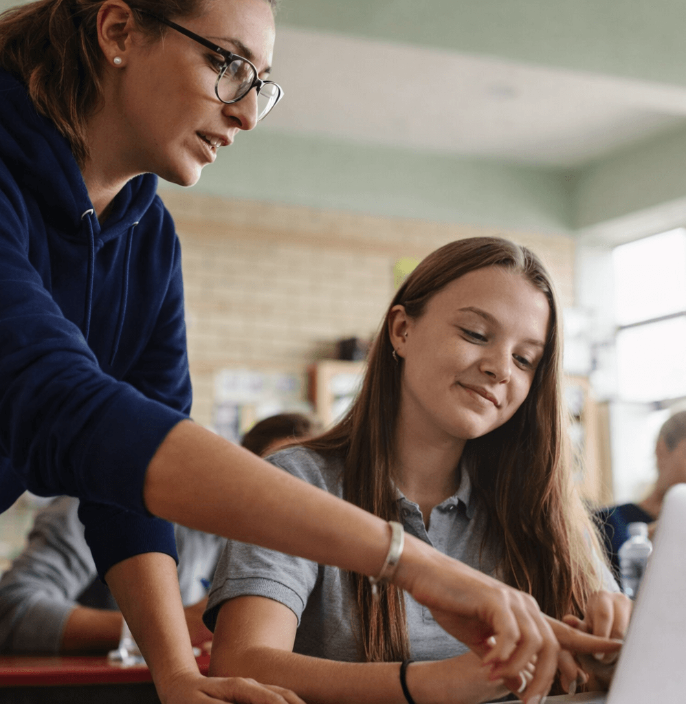 Teacher assisting a student in the classroom